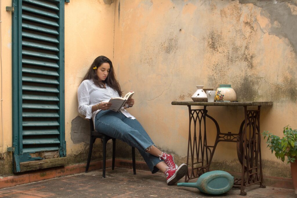 woman reading a history text book in a rustic setting